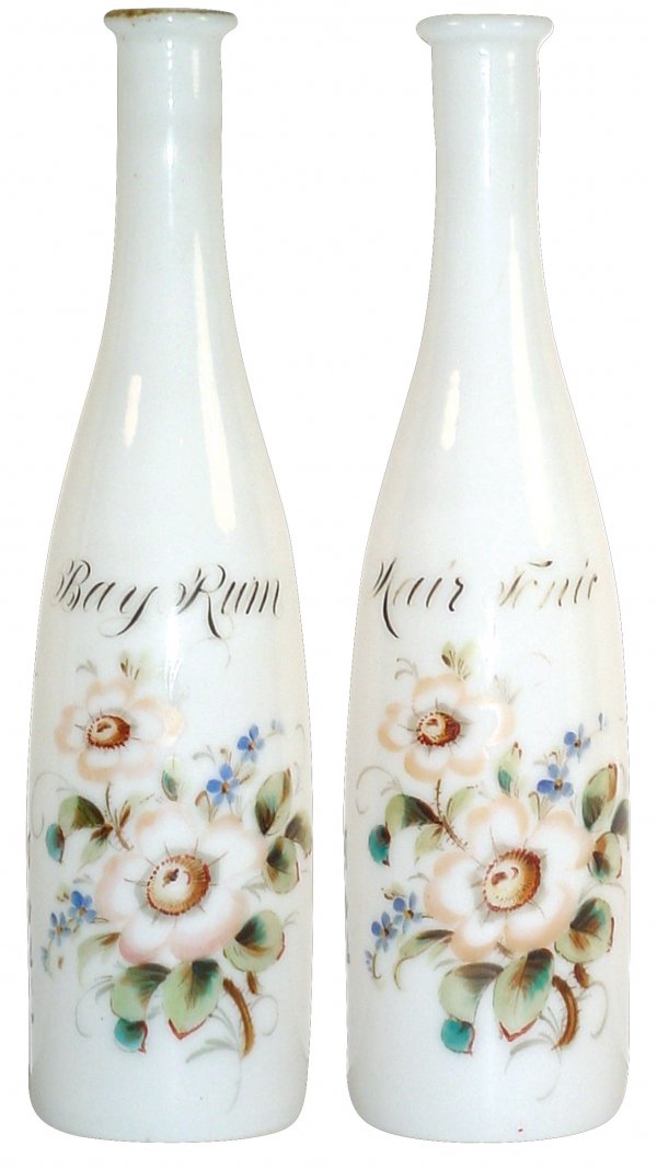 Barber bottles (2); matched pair of milk glass "Ha: Barber bottles (2); matched pair of milk glass "Hair Tonic" & "Bay Rum" bottles w/vivid enameled flowers, bottom stenciled "Melchoir Bros. Barber Supply Co.", minor fading of lettering, VG condition,
