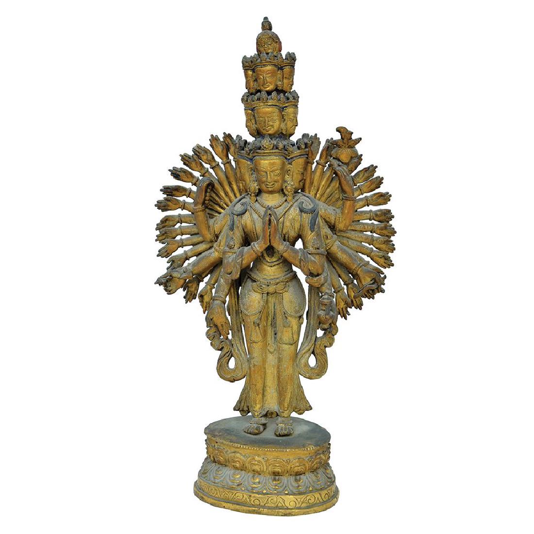 A GILT BRONZE FIGURE OF ELEVEN-HEADED THOUSAND-ARMED: Chinese-Tibet late 19th century The bodhisattva stands on a double-lotus base with the principle hands in anjalimudra six others with Buddhist symbols and the multitude of others outstretched around h