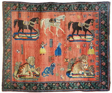 AN OLD CAUCASIAN KARABACH RUG: Dogs and horses on a dusty pink ground, roses in the border on a green ground, 195x165 cm.