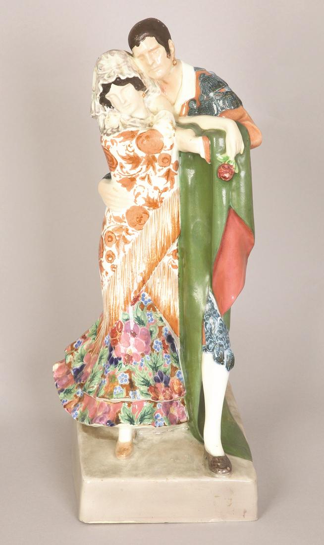A GOLDSCHEIDER FAYENCE FIGURE GROUP 'SPANISCHES PAAR: C. 1922. STAMPED 'Goldscheider ', SIGNED 'PERL' (KARL PERL) AND NUMBERED 5001 34 25. 39 cm high (Minor damage to skirt and some flaking).