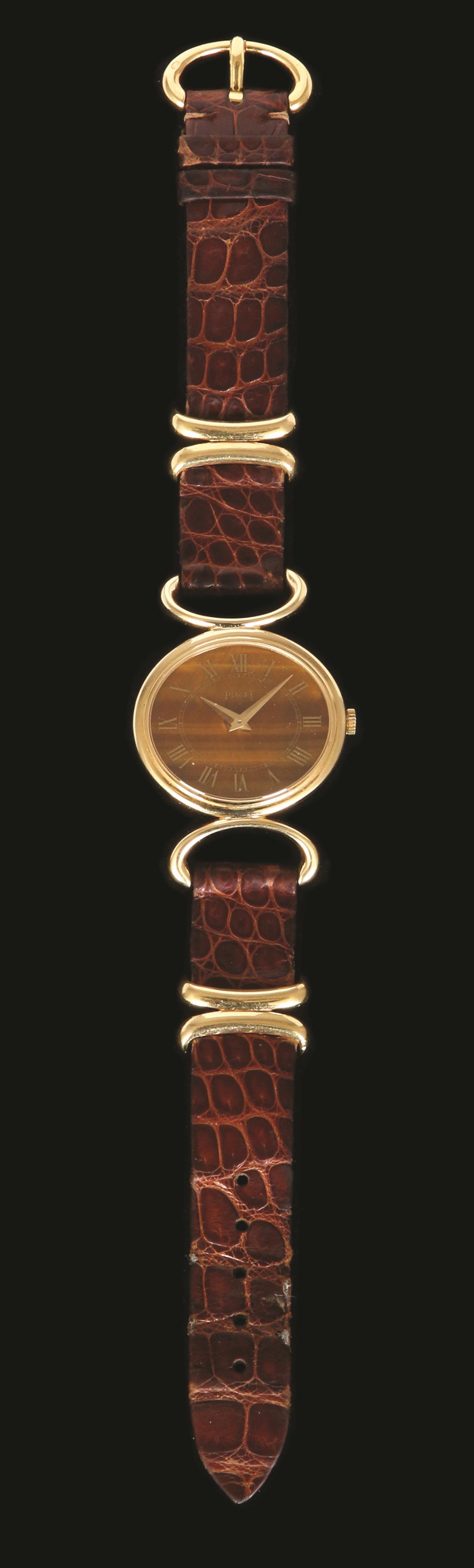PIAGET 18K GOLD WRISTWTCH: Tiger eye, mechanical mechanism, dimensions: 26X23 mm. original brown leather strap and 18K gold buckle.