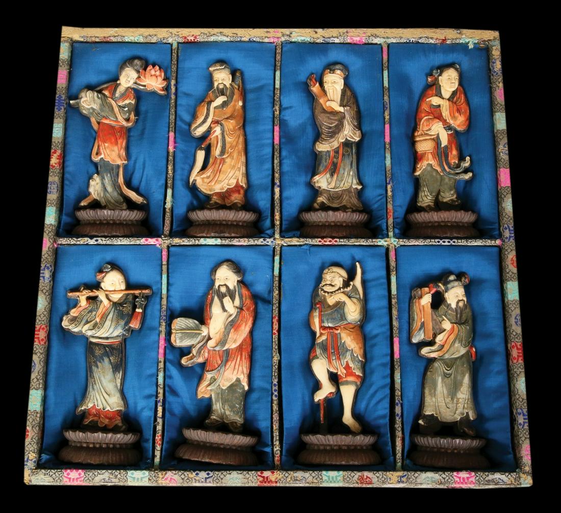 IMPERIAL COURT CREW. EIGHT CHINESE BONE SCULPTURES: circa 1950. Polychrome colored. Placed on wood background and placed on a base. Bases are signed China in the wooden box. Sculpture height (excluding bases): 13-14 cm.