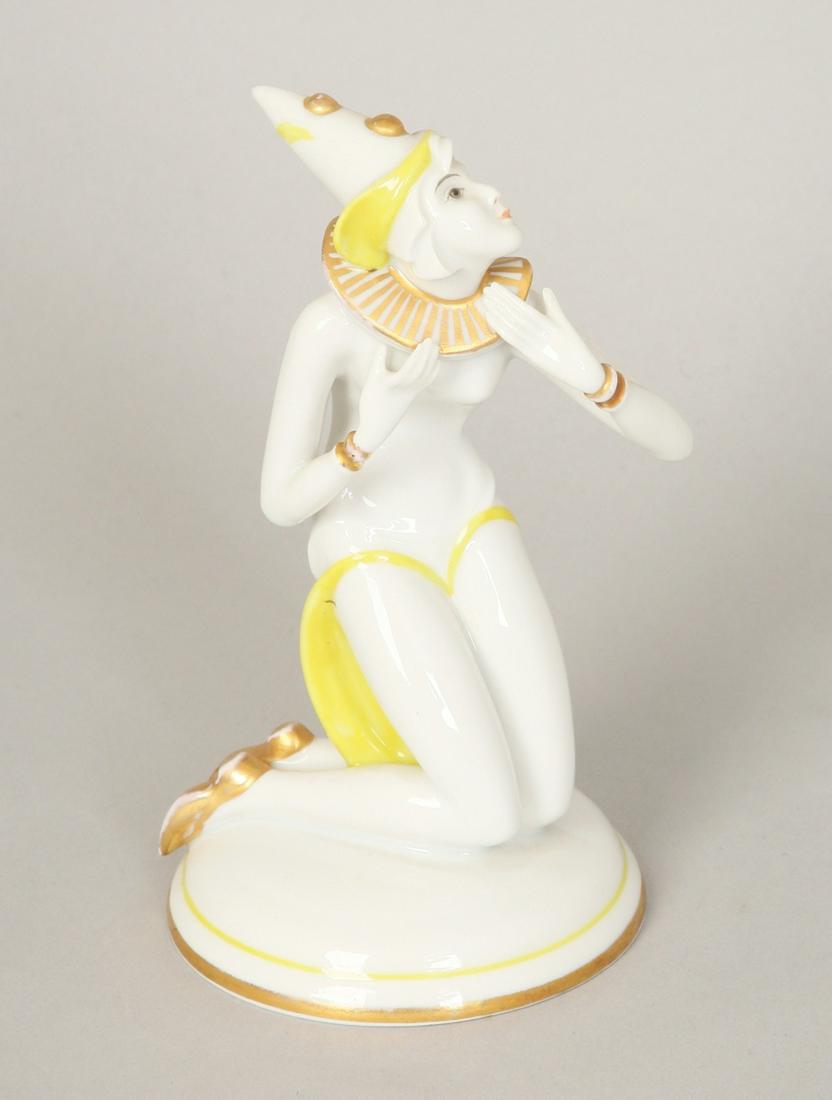 A SCHLAGGENWALD ART DECO STYLE PORCELAIN FIGURE OF A: Czech Republic,20th Century. Modeled as a dancer dressed in a clown costume with gilt accents. Marked. 14.5 cm high.