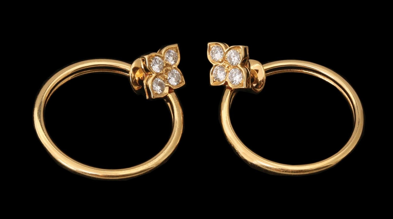 A PAIR OF 18K GOLD CARTIER EARRINGS: Hoop decorated with a leaf set with diamonds. Total diamond weight is appeox. 0.80 ct.