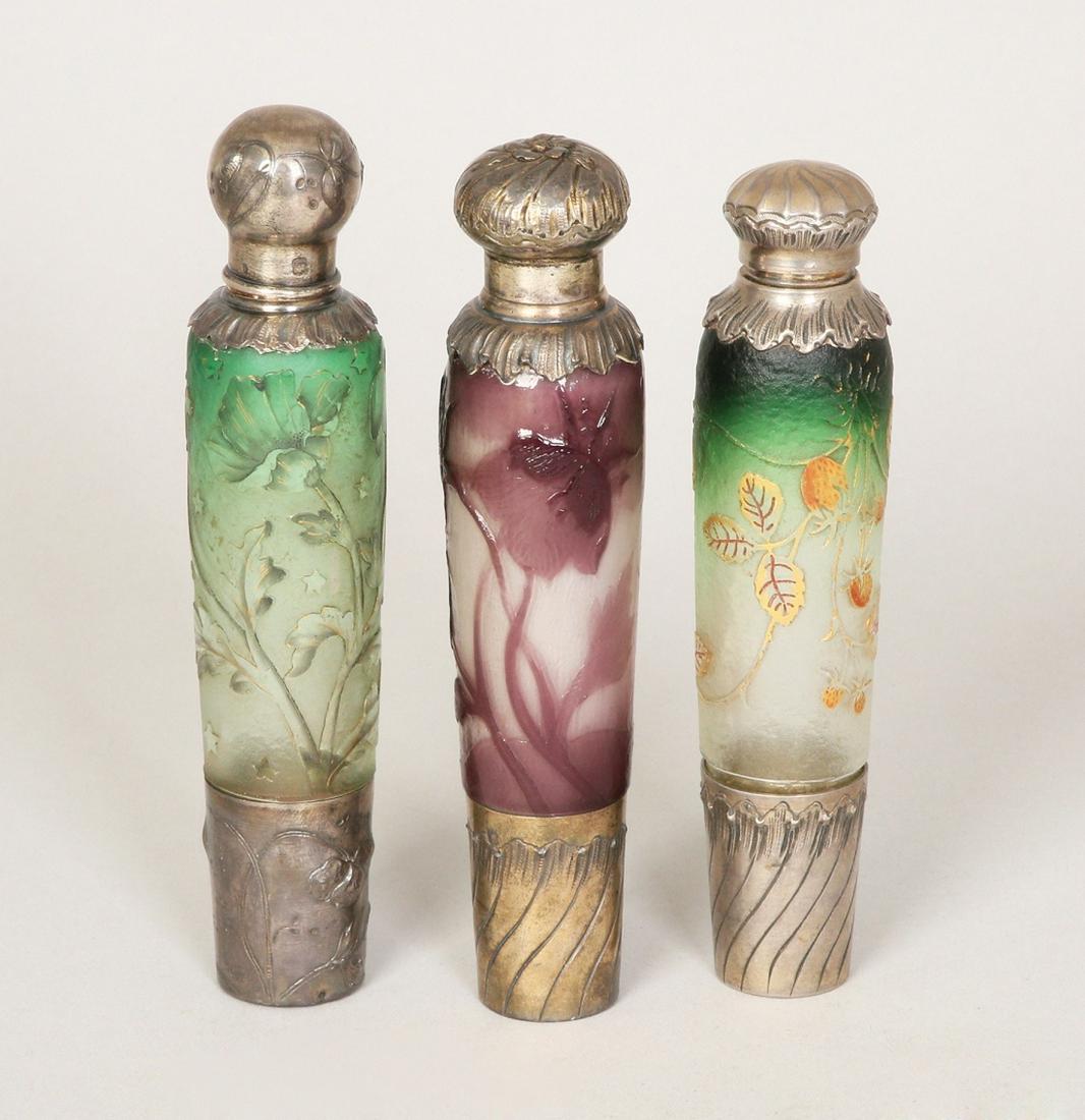 A LOT OF THREE FRENCH CAMEO GLASS AND SILVER LIQUOR: C. 1910. Includes removable silver shot glass. Comprising: a. Galle. Purple flowers and leaves. Marked in etch 'Cristalleri de Galle Nancy'. b. Daum Nancy. Flowers, leaves and stars on green to white 
