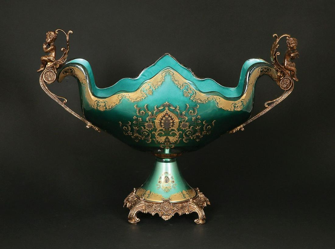 A EUROPEAN GILT METAL AND GLASS CENTERPIECE: 20th century. Gilt decoration in many classical motifs. 34x48 cm.