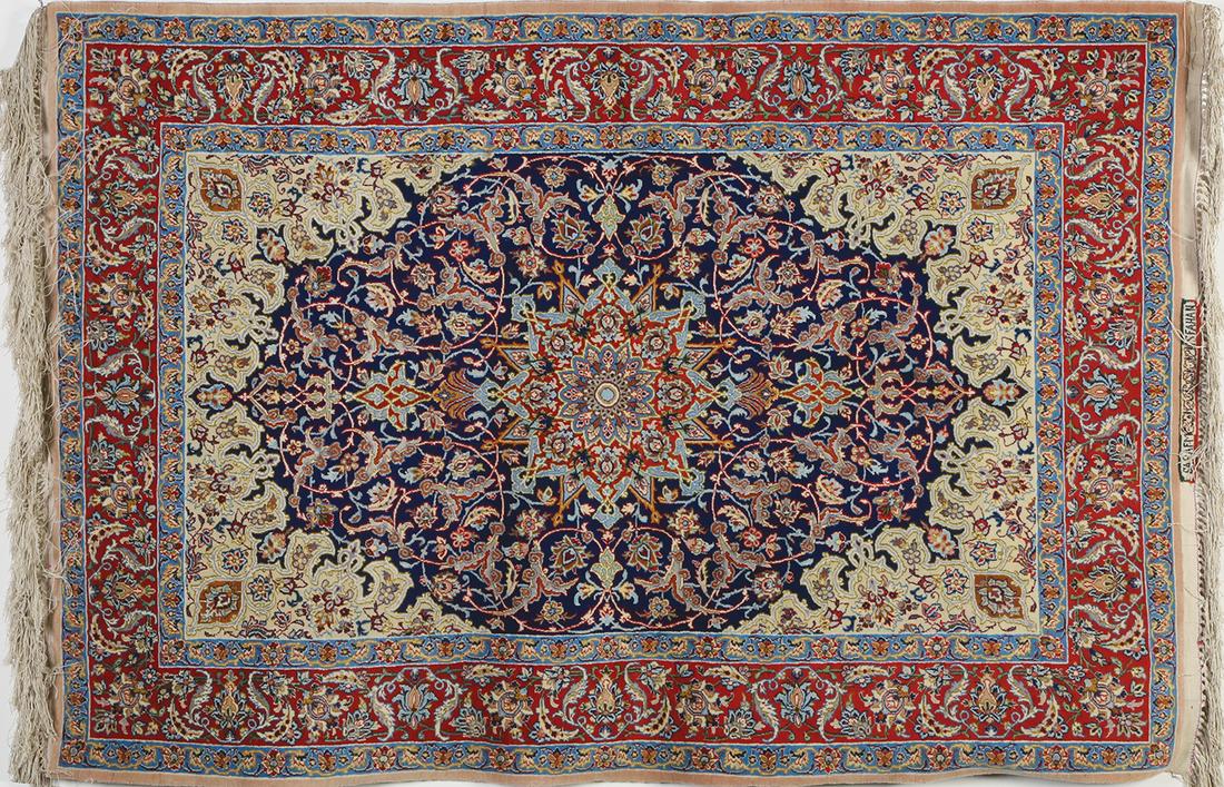 AN OLD ISPAHAN, PERSIA RUG: The surface is ornamented with a large ornament withing a blue frame on light color field. Shah-Abbas flowers over light blue and red borders. 111X160 cm.