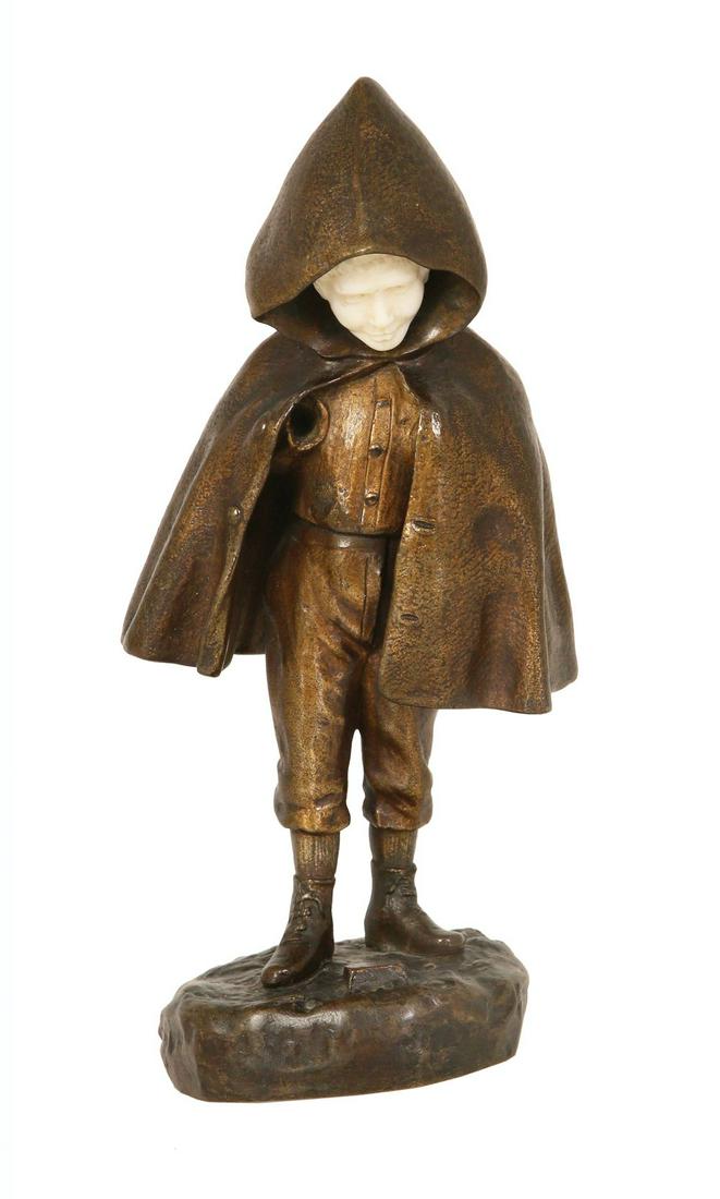 A BRONZE SCULPUTURE OF A BOY IN A CAPE: Maked Chopard. 22 cm high