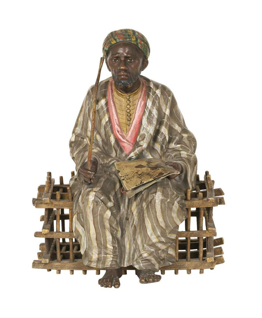 A FRANZ BERGMAN COLD PAINTED BRONZE FIGURE OF A SEATED MAN WITH A BOOK (1 of 1)