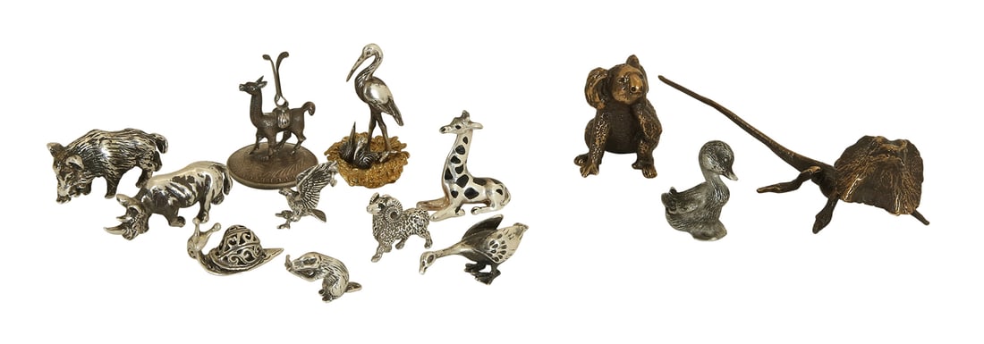 LOT OF 13 SILVER AND BRONZE MINIATURES: Including 10 silver miniatures and 3 bronze. Depicting animals such as: eagle, goose, stag, rhinoceros, wild boar, giraffe, stork with chicks, snail, llama, beaver, lizard, koala and duckling. Most