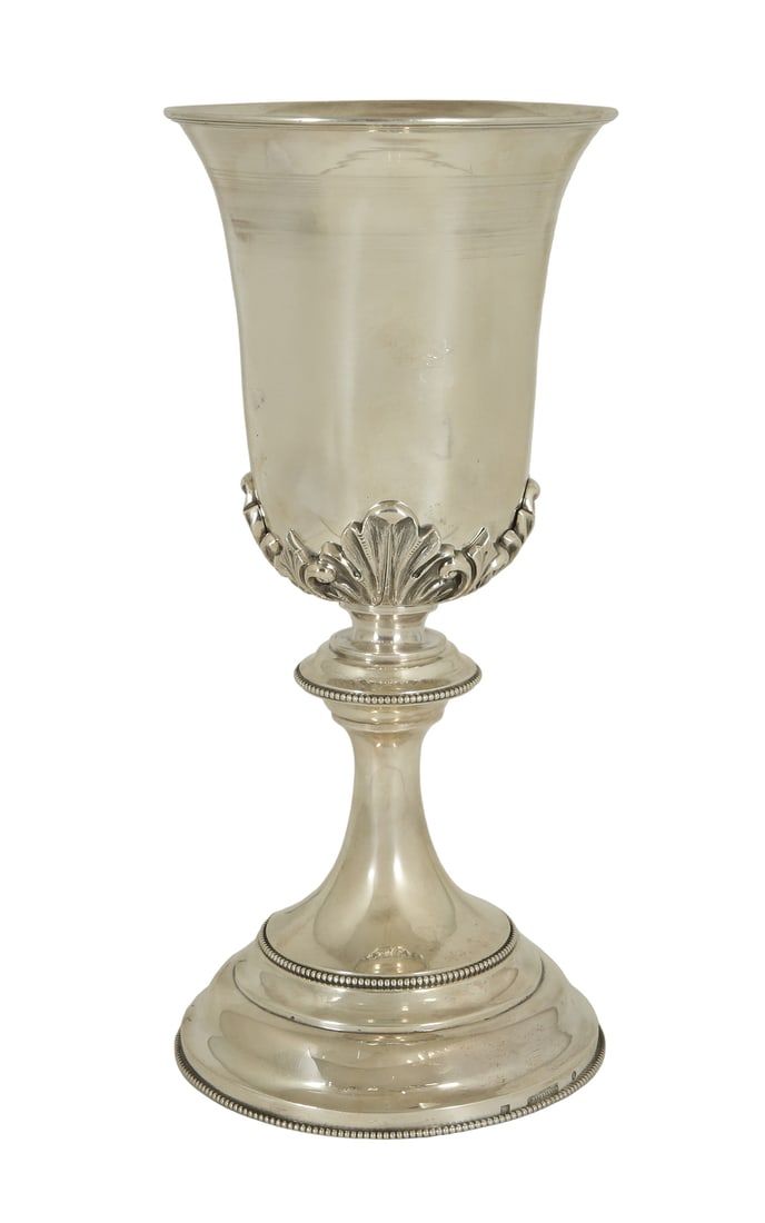 LARGE DUTCH KIDDUSH CUP: 1885. Decorated with rocaille leaves and pearls. Gilded interior. Signed. Weight: approx. 463 g. Height: 25.5 cm.