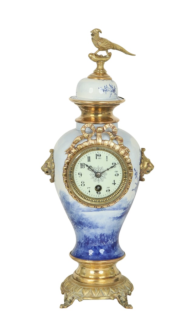 AN ANCIENT BRONZE AND PORCELAIN CLOCK (1 of 2)