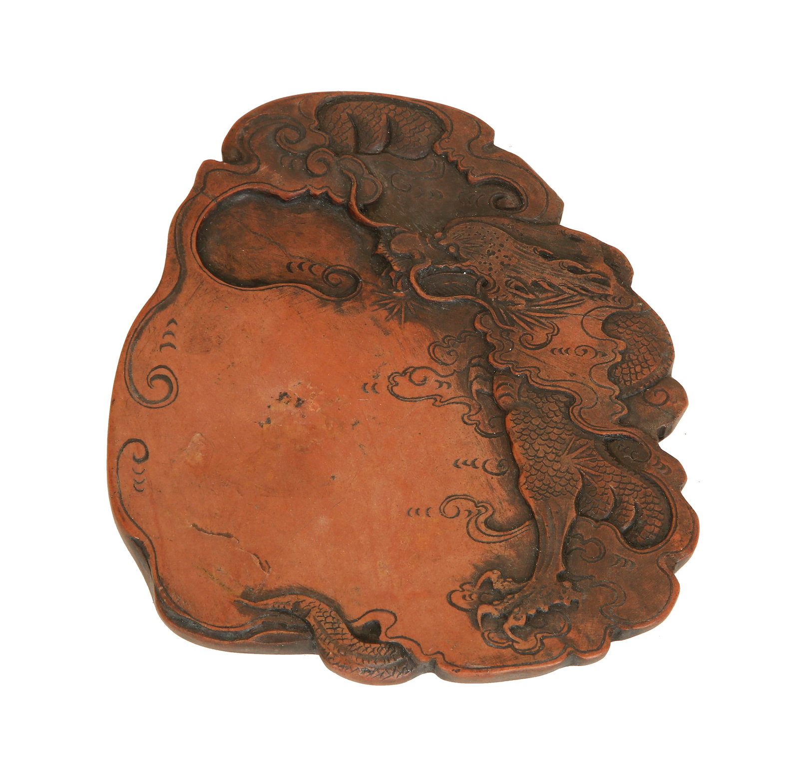 ANTIQUE CHINESE INKSTONE: 18th century - early 19th century. Made of DUANSHI stone. Decorated with relief carving of a dragon and celestial elements. Housed in a wooden cover. Signed in a poem. Length: 10.5 cm. Old repair.