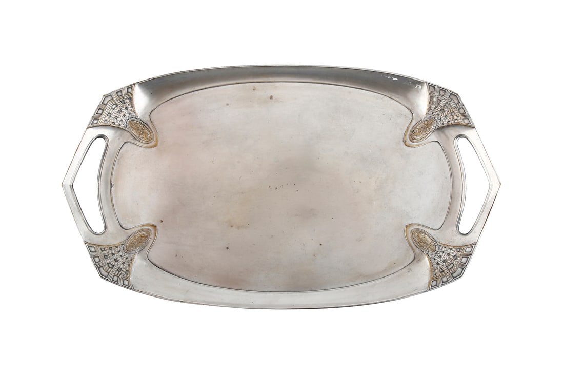 WMF. GERMAN SILVER-PLATED TRAY: Art nouveau, 1909. Decorated with geometric patterns and four dolphins set within medallions. Pointed handles. Signed. Length: 59 cm.