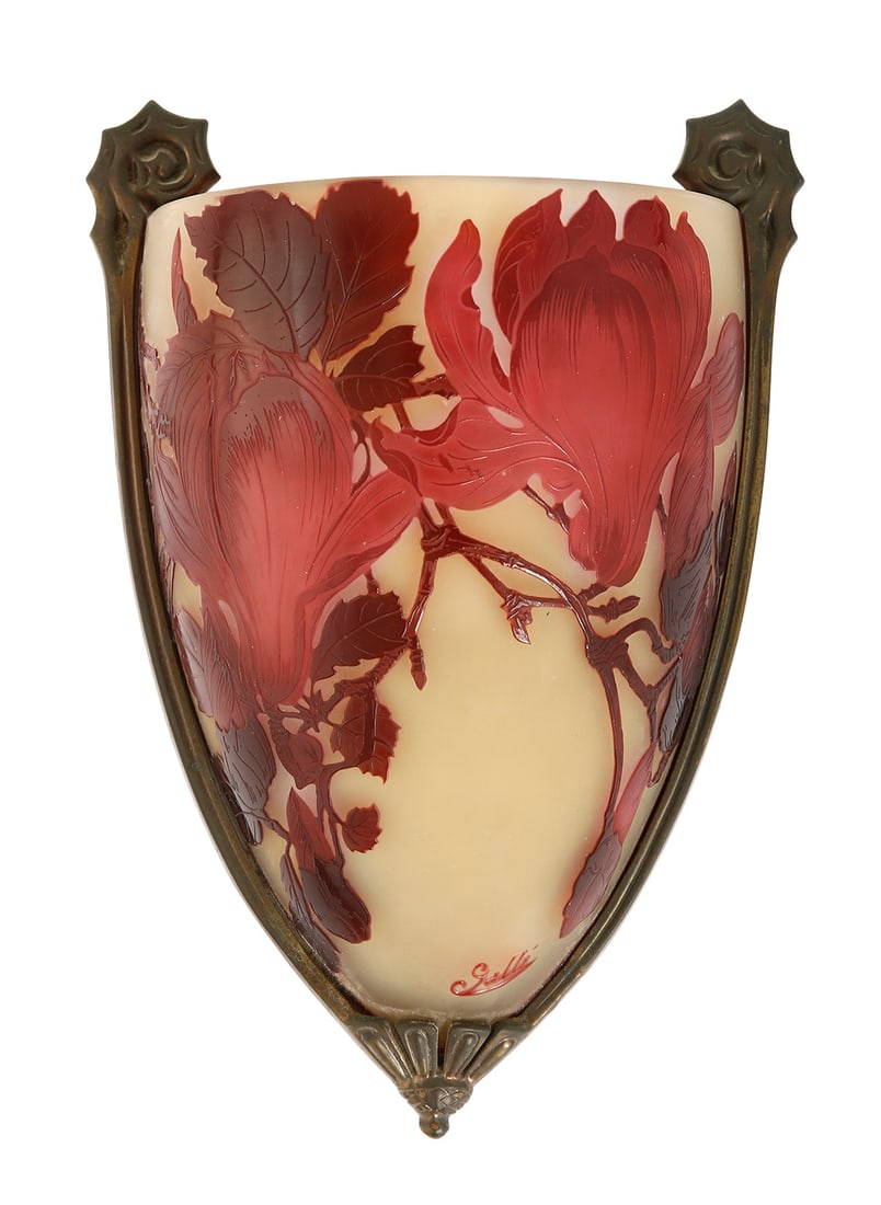 GALLE. FRENCH ART NOUVEAU WALL LAMP: Circa 1904. Cameo glass vase made of cameo glass, decorated with red magnolia buds and flowers acid-etched against a yellow ground. Set in an ornamented brass mount. Signed in Cameo. Height: 28 cm.