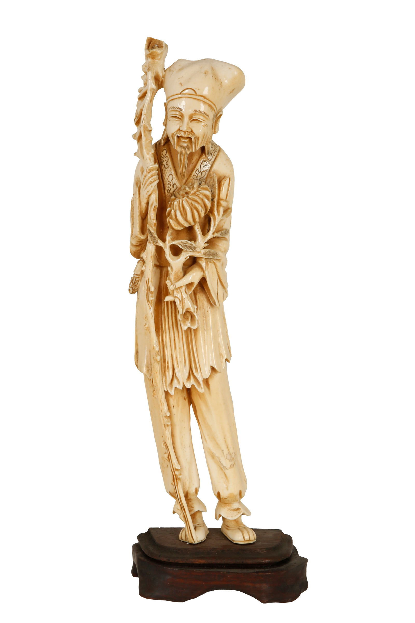 WISE OLD MAN AND CARNATION: Late 19th century / early 20th century. Made of organic material. Set on a wooden base. Overall height: 34 cm.