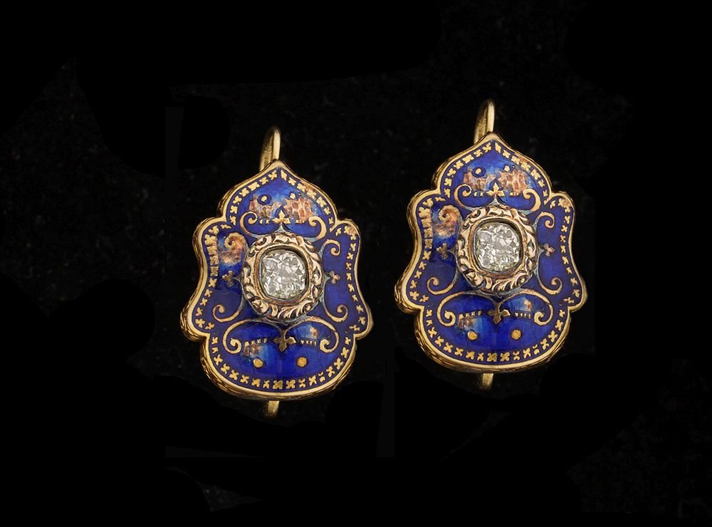 A PAIR OF 14K GOLD EARRINGS: Russian, antique, curvy frame decorated in the center with royal blue onyx and set with an old cut diamond.