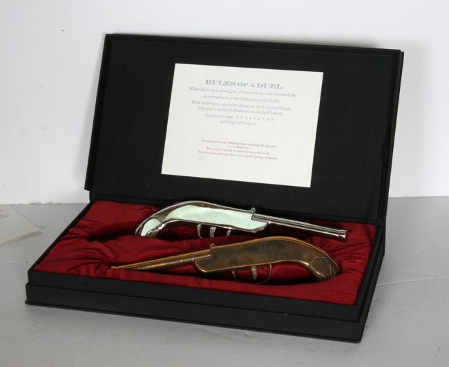 Vik Muniz, Drunken Duel, Two Bronze Pistols: Artist: Vik Muniz, Brazilian/American (1961 - ) Title: Drunken Duel Year: 1991 Medium: Two Bronze Pistols (One Silver Plated) Edition: 26 (Letter I) Size: 16 in. x 9 in. x 2 in. (40.64 cm x 22.86 cm x