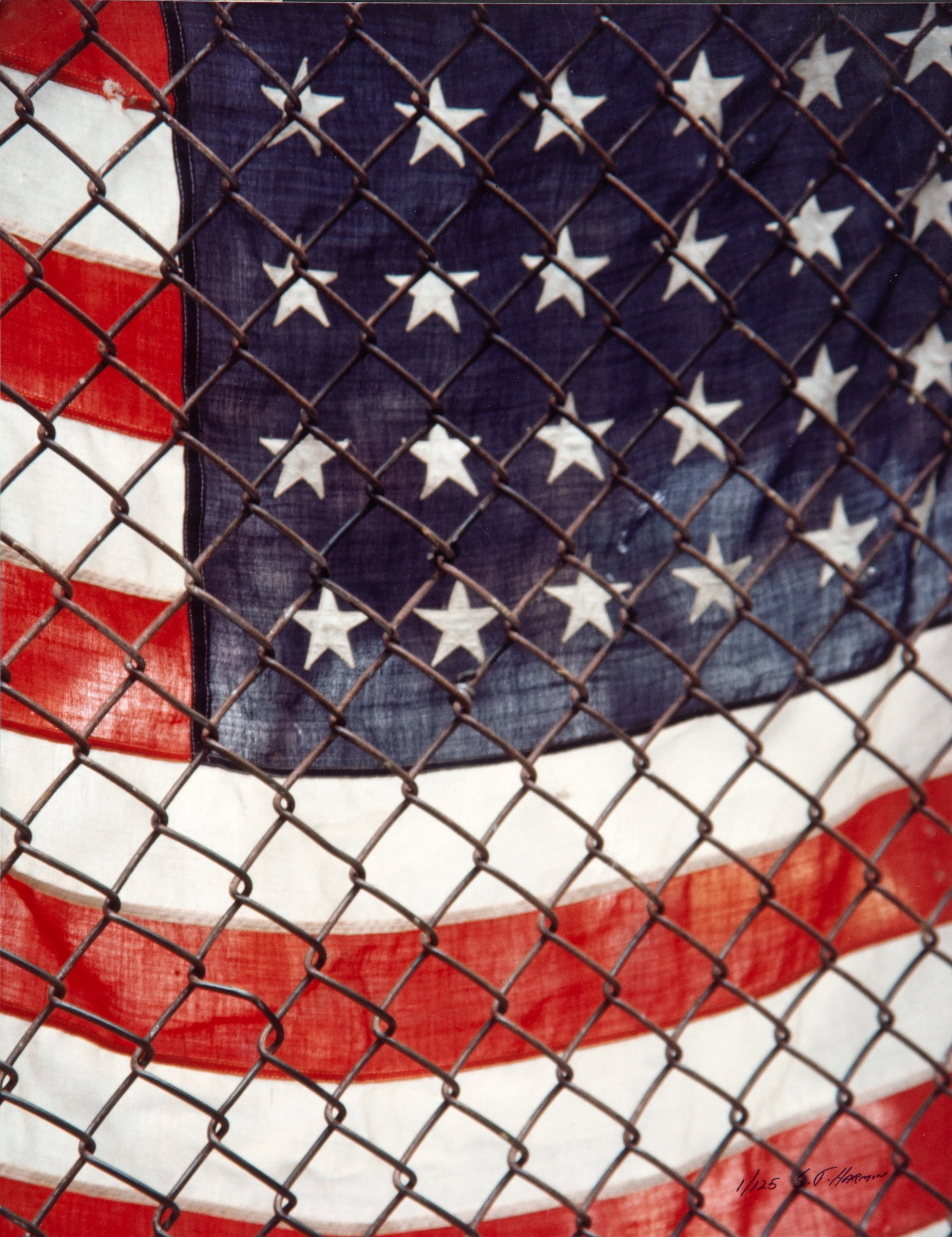 SF Harmon, American Flag, Photograph: Artist: SF Harmon Title: American Flag Behind Chain-Link Fence Medium: Chromogenic Print, signed and numbered in pen Edition: 1/125 Size: 14 x 11 in. (35.56 x 27.94 cm)