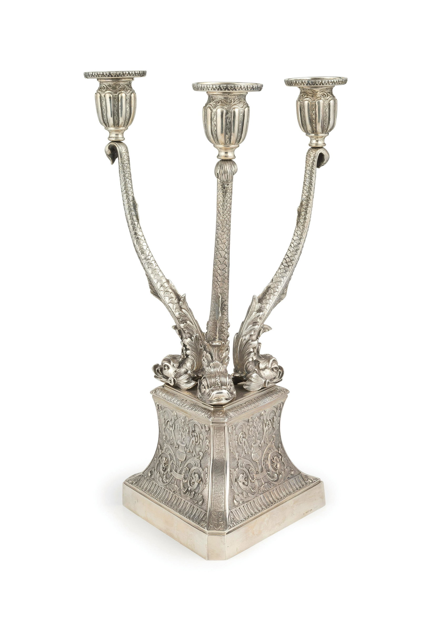 CANDELABRO IN ARGENTO, MILANO, XX SECOLO,: ORAFO M. BUCCELLATI a tre bracci a foggia di delfini poggianti su plinto triangolare decorato a motivi naturalistici- usure Alt. cm 36, larg. cm 21- peso totale gr 1985 AN ITALIAN SILVER CANDELABRUM, 