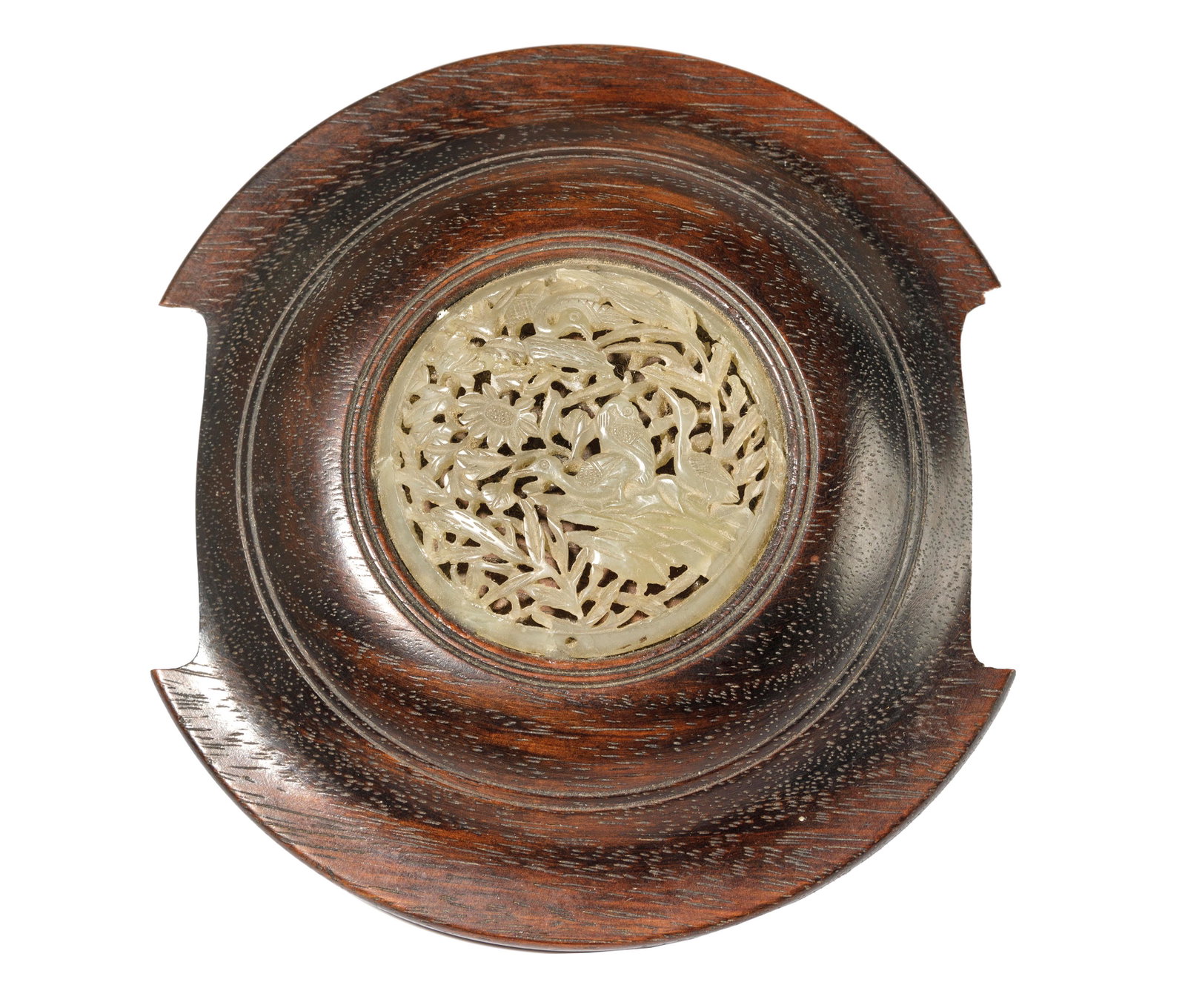 A WOOD COVER WITH PALE CELADON JADE INSERT, CHINA, 19TH: The insert of a green pale tone, incised as openwork depicting birds and flowers. In good conditions, minor wear on the surface. 12,4 x 11, 4 cm diam. Provenance: from the important mansion in Rome of
