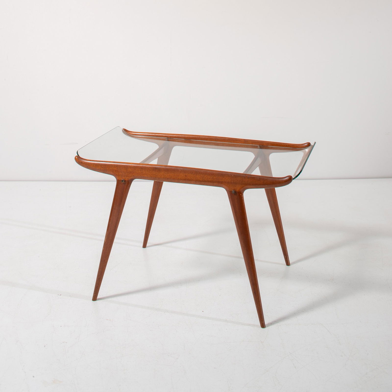 CARLO DE CARLI, RENATO ANGELI: Tavolino smontabile. Legno di ciliegio, ottone, cristallo curvato e molato. Italia anni '50. cm 53x81x47 AN OCCASIONAL TABLE BY C. DE CARLI & R. ANGELI Cfr.: I. de Guttry, M. P. Maino, Il mobile itali