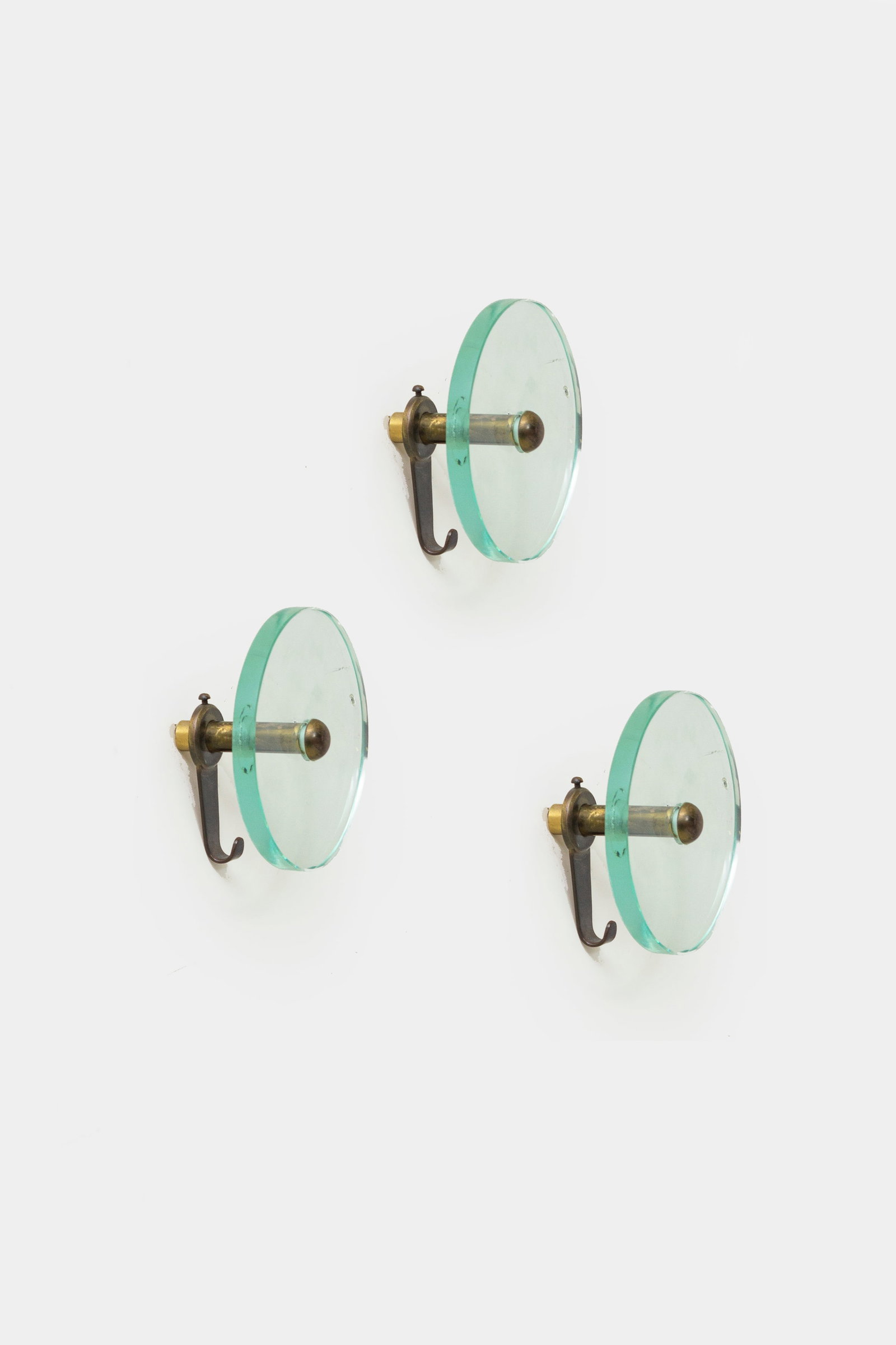 CRISTAL ART: Tre appendiabiti. Ottone, cristallo molato. Anni '50. cm 12x7 THREE COAT HANGERS BY CRISTAL ART Condizioni molto buone. Piccole righe e segni di usura, ossidazione.