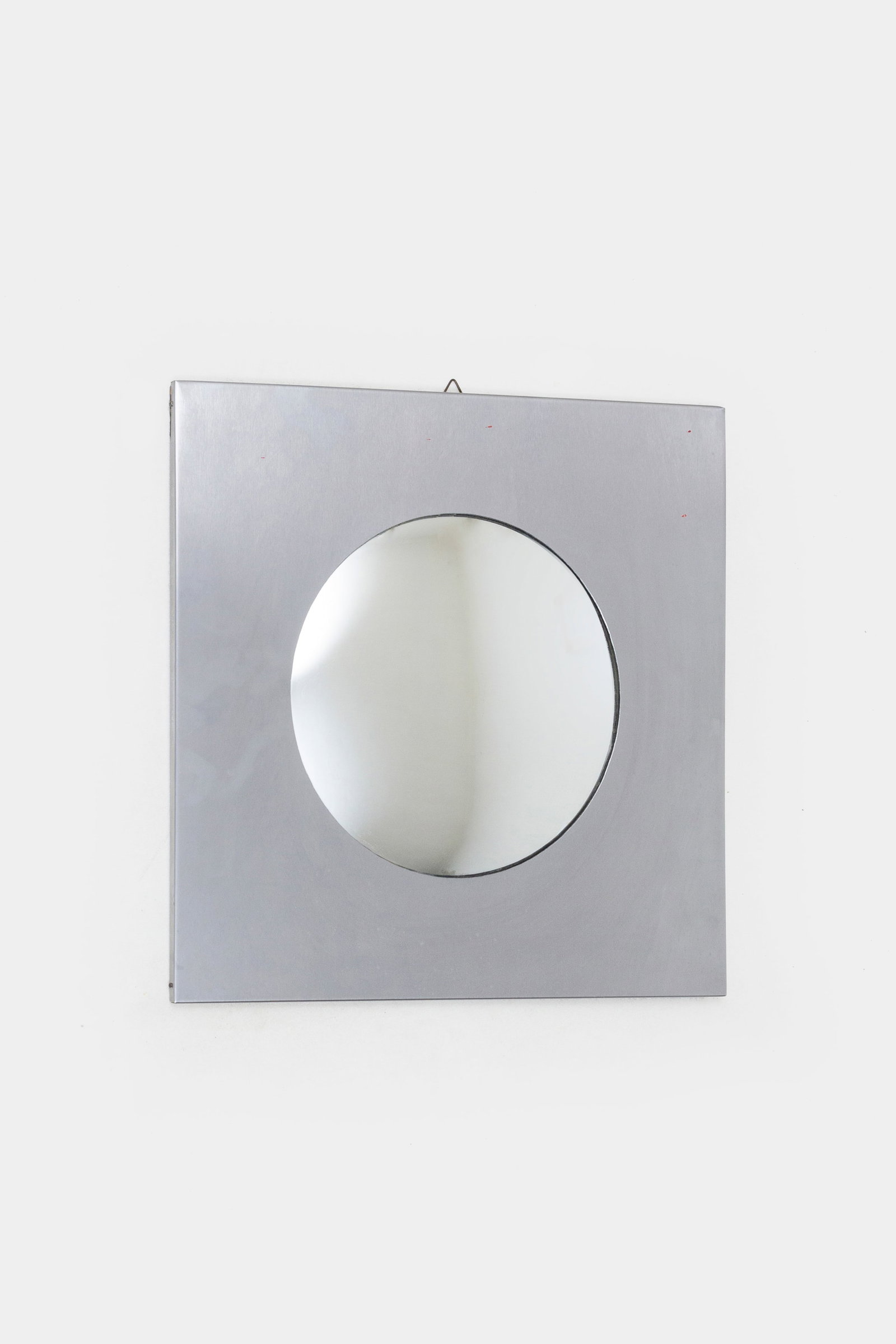 SAPORITI: Specchio da parete. Metallo spazzolato, vetro curvato specchiato. 1960 ca. cm 45x45x3 A WALL MIRROR BY SAPORITI Buone condizioni. Piccole righe e segni di usura. Lieve ossidazione.