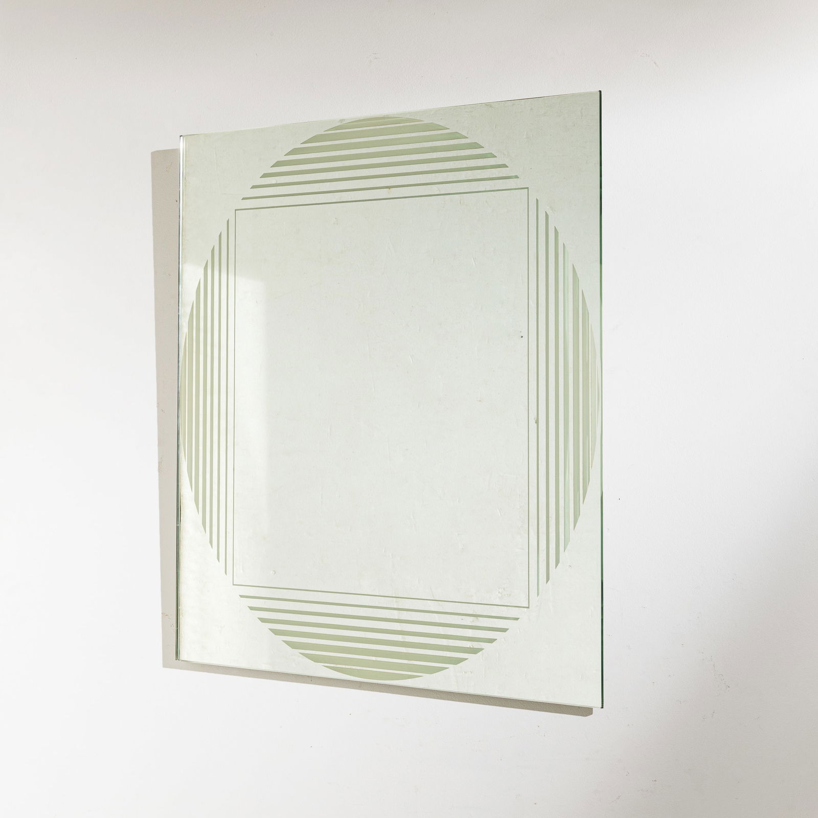 GIANNI CELADA: Specchio mod. Brama. Vetro serigrafato e specchiato, metallo. Produzione Fontana Arte fine anni '60. cm 70x70x3 A MIRROR BY G. CELADA L. Falconi, Fontana Arte una storia trasparente, Skira, Milano, 19