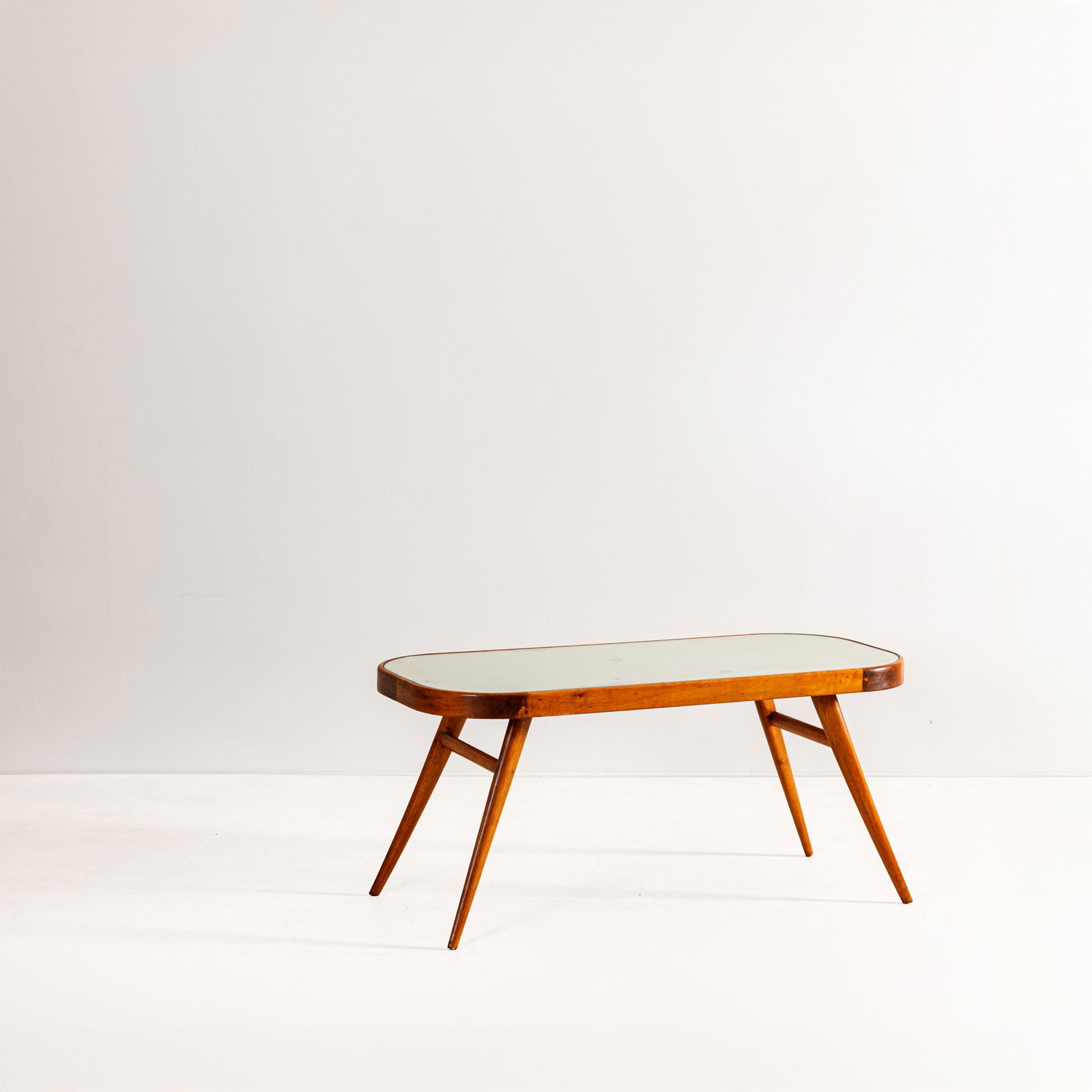 PIETRO CHIESA: Tavolo basso. Legno tinto, cristallo specchiato e molato. Produzione Fontana Arte, fine anni '30, marchio della manifattura sul legno. cm 47x100x46 ca. A LOW TABLE BY P. CHIESA Cfr.: Domus n.140,