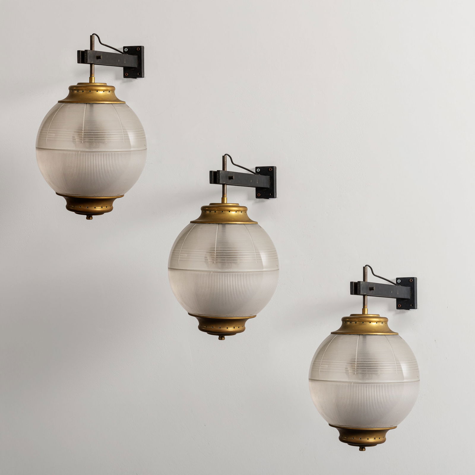 CHIARAVALLOTI: Tre lampade da parete mod. A/567. Metallo verniciato, ottone, vetro stampato. Italia anni '50. cm 46x25x40 THREE WALL LIGHTS BY CHIARAVALLOTI Catalogo di produzione, p. 43 Buone condizioni