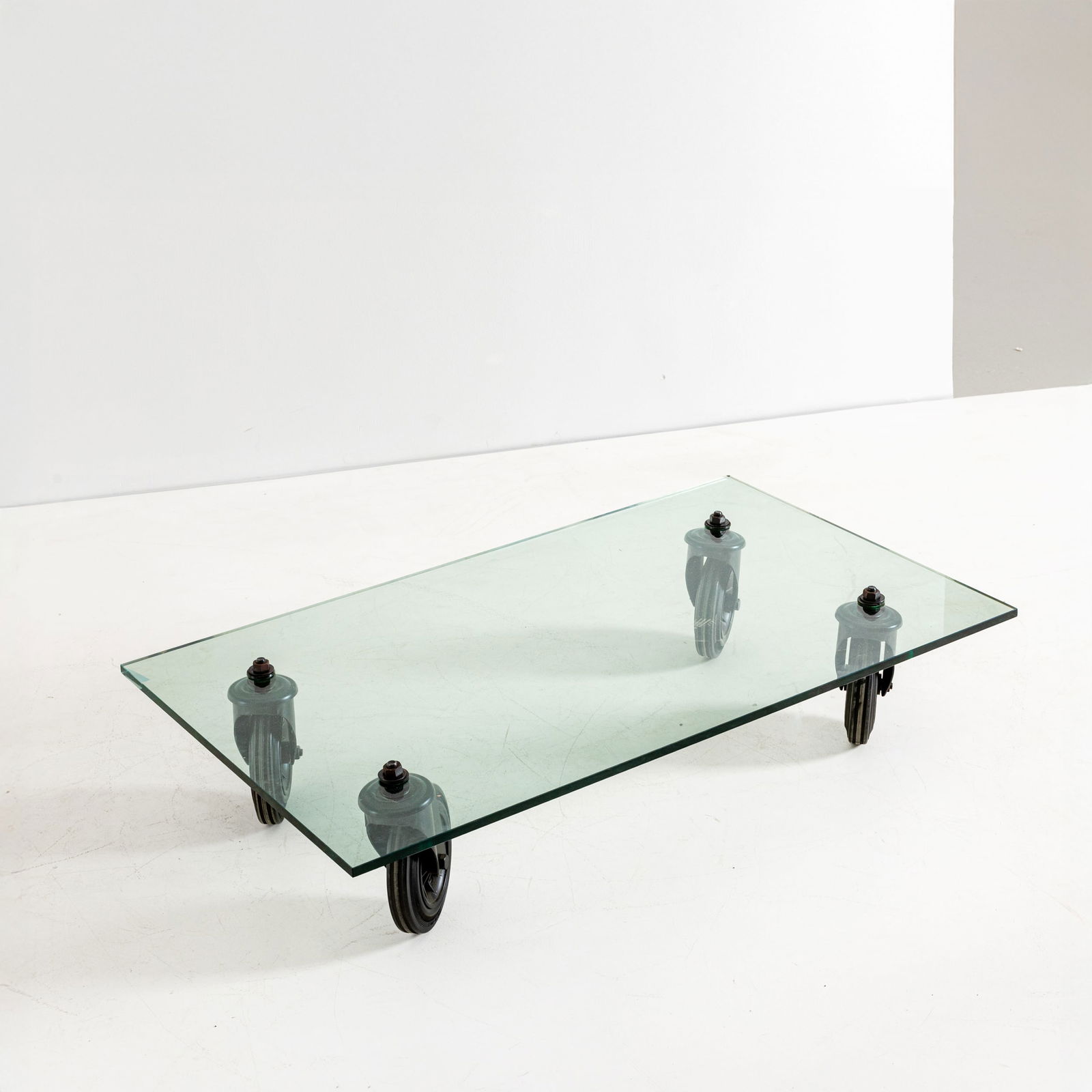 GAE AULENTI: Tavolo basso. Metallo, gomma, cristallo molato. Produzione Fontana Arte, 1980 ca. cm 25x120x70 A LOW TABLE BY G. AULENTI G. Gramigna, Repertorio del design italiano 1950-2000 per l'arredamento
