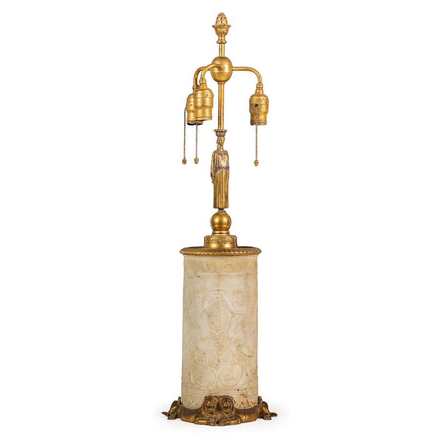 LAMPADA IN MARMO E BRONZO DORATO, XIX SECOLO: a tre luci sorrette da erma di modello classico, base a tronco di colonna in marmo antico ornata da putti antropomorfi e girali lavorati a bassorilievo; difetti, minori sbeccature e graffi nel marmo,