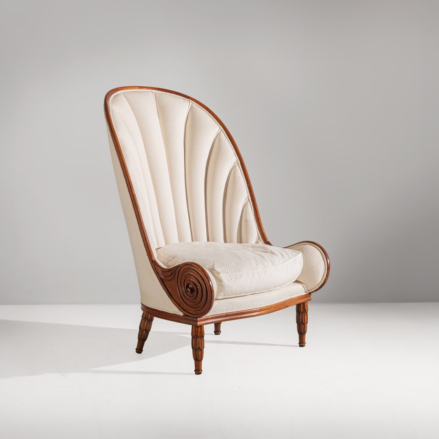 PAUL IRIBE: Poltrona mod. Nautilus. Legno di noce tinto, tessuto imbottito. Edizione Annibale Colombo anni '70. cm 125x81x90 ca. AN ARMCHAIR BY P. IRIBE Condizioni molto buone. Righe e graffi, trascurabili