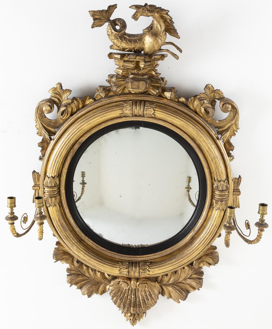 Regency Giltwood Convex Girandole Mirror, 19th C.: Property from a Private Collector, Bluffton, SC issuing double candlearms, surmounted by a hypocampus, the base carved with a shell. H. 52 1/2 in. x W. 36 in.