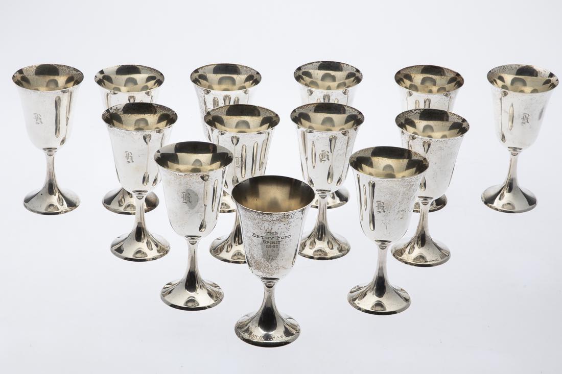 13 Sterling Silver Goblets: Property from a Savannah Collector 12 engraved with an initial and marked Ellmore Silver Company, one engraved 'The Betsy Ford Spirit, 1961, Marsha Hass' and marked Amston Sterling. 53.63 troy ounces.