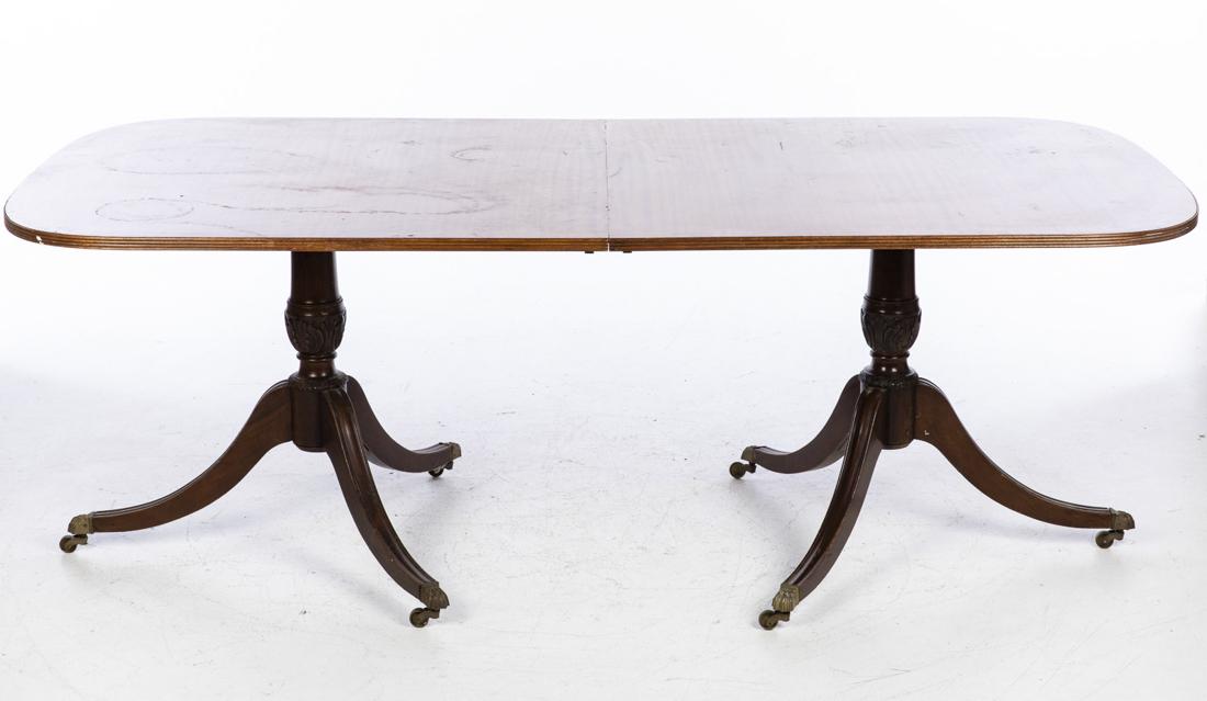 George III Style Mahogany Two-Pedestal Dining Table: George III Style Mahogany Two-Pedestal Dining Table, the rectangular top above carved pedestal supports, ending in caps and casters. Height: 30 in. x Width: 83 in. x Depth: 42 1/2 in.