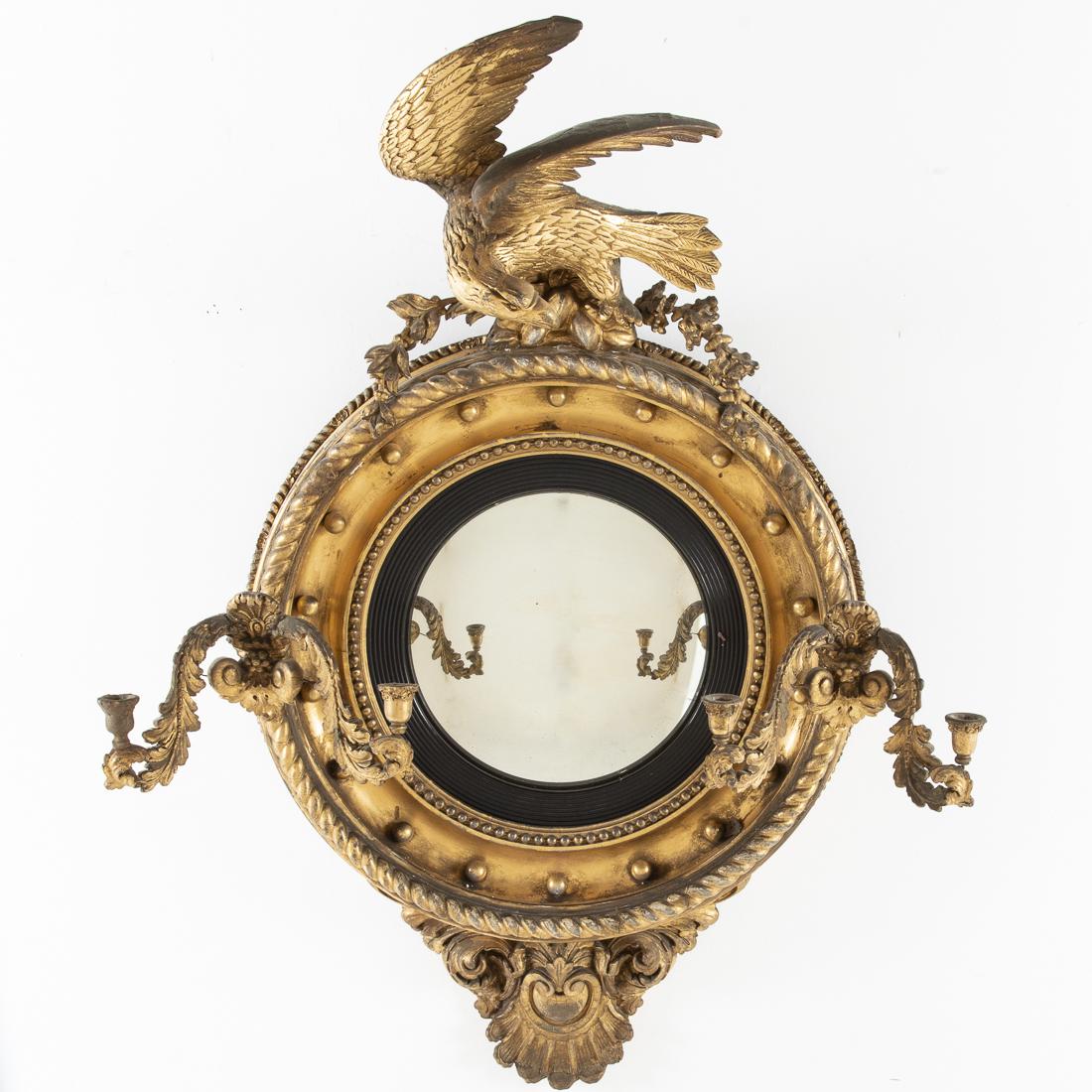 Victorian Giltwood Convex Mirror, 19th Century: Property of a Private Collection, Savannah, GA issuing double candlearms, surmounted by an eagle and with carved apron. Approximate size: H. 45 in. x W. 35 1/4 in.