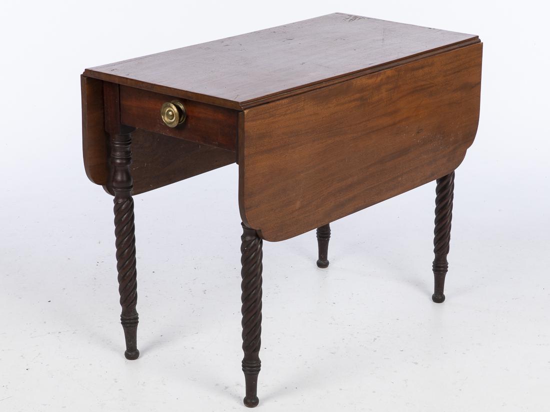 American Drop Leaf Table, 19th Century: Property from a Savannah, GA Estate with shaped leaves above a drawer, raised on spiral carved legs ending in ball feet. Size open: H. 29 in. x W. 44 1/4 in. D. 38 in.