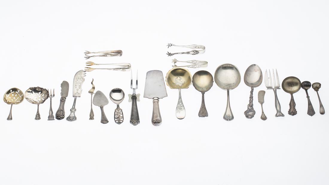 18 Sterling Silver Pieces of Flatware and 5 Others: Property from a Private Collection Savannah, GA with various designs and makers. Comprising 4 large serving spoons, 1 serving forks, 1 cheese knife, 1 cake knife, 2 pierced spoons, 3 sugar tongs, 3 la