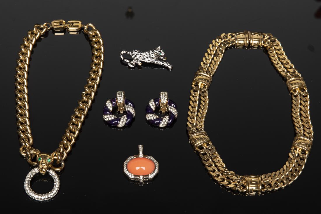 Group of Costume Jewelry including Givenchy: Property from a Savannah, GA Estate comprising a costume gold chain necklace, another costume gold chain necklace with jaguar pendant marked 'Givenchy', an orange pendant with imitation diamonds marke