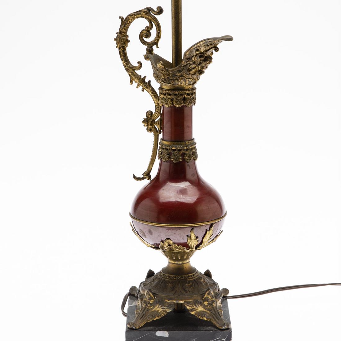 Renaissance Style Pitcher Now Mounted as a Lamp: Property from the Collection of Lady Grundy, Cocoa Beach, FL Renaissance Style Pitcher Now Mounted as a Lamp, red enamel and gilt metal Renaissance style pitcher on a stone base, mounted as a lamp. He