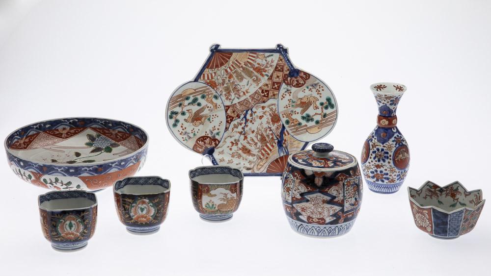 8 Pieces of Imari Porcelain: Property from a Savannah, GA Estate comprising a bowl, lidded jar, 7 1/2 in. vase, 3 square cups, shaped serving plate and a pointed edge small bowl. Height of lidded jar: 5 1/2 in. Width of bowl: 10 