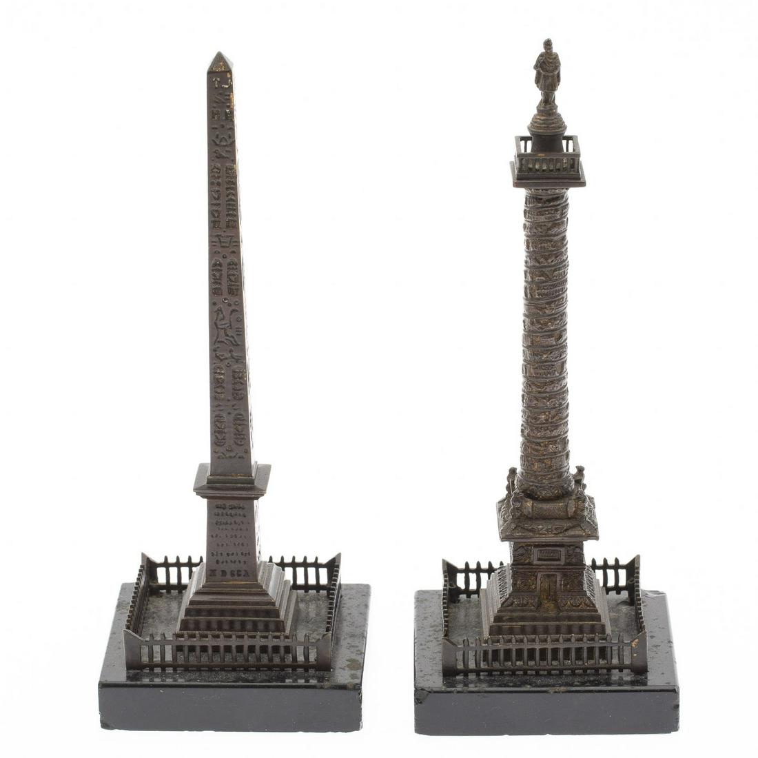 Two Grand Tour Bronzes of Roman Monuments: Two Grand Tour Bronzes of Roman Monuments, comprising a replica of Trajan's Column and an Egyptian Obelisk, both on a square stone base. MEASURMENTS: Height: of both 7 3/8 in. x Width: 3 in. x Depth: