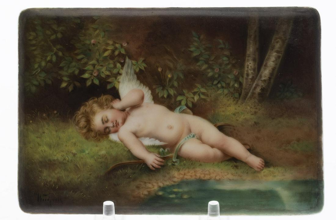 German Painted Porcelain Plaque signed Wagner: German Painted Porcelain Plaque signed Wagner, with paper label on the back 'Julius Greiner Sohn, Dresden A. Pragerstr. 25', with impressed mark in one corner, depicting the sleeping Cupid by a river,