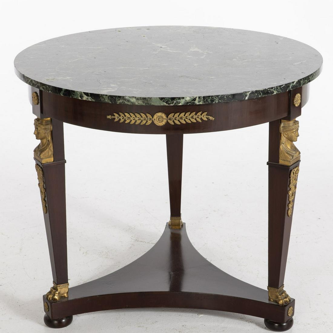 Empire Style Mahogany Marble Top Center Table, 20th C: Empire Style Mahogany Marble Top Center Table, 20th C., the circular green marble top above a frieze raised caryatid supports, joined by a concave sided platform stretcher, on flattened ball feet. MEA