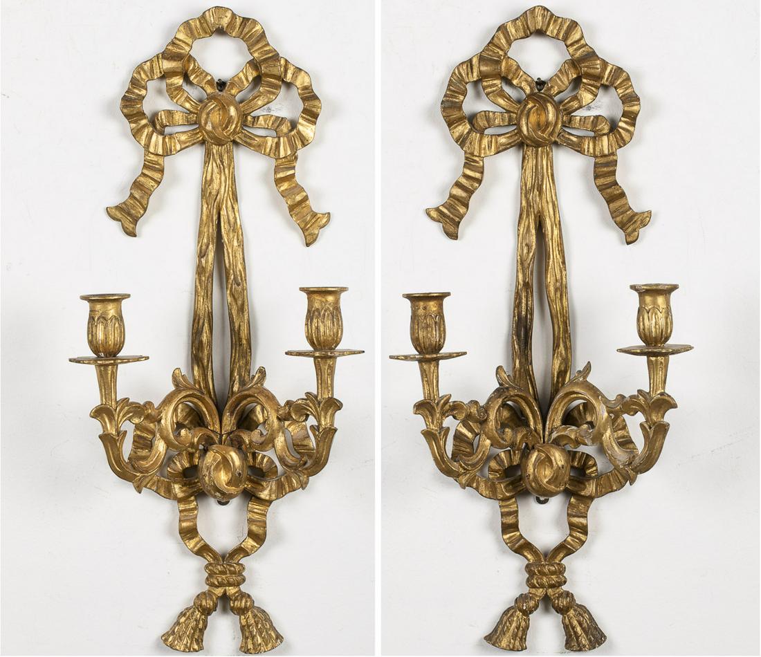 Pair of Giltwood Two-Light Wall Sconces: Pair of Giltwood Two-Light Wall Sconces, with two candle arms and ribbon and sash form design. MEASURMENTS: Height: 24 in. x Width: 11 1/2 in. x Depth: 5 in.