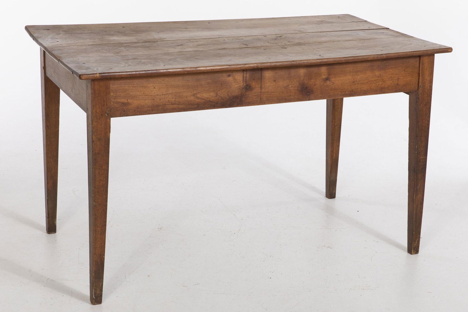 French Walnut Farm Table, 19th Century: French Walnut Farm Table, 19th Century, the rectangular plank top above a drawer on one end raised on square tapering legs. MEASURMENTS: Height: 30 1/2 in. x Width: 52 1/4 in. x Depth: 29 in.
