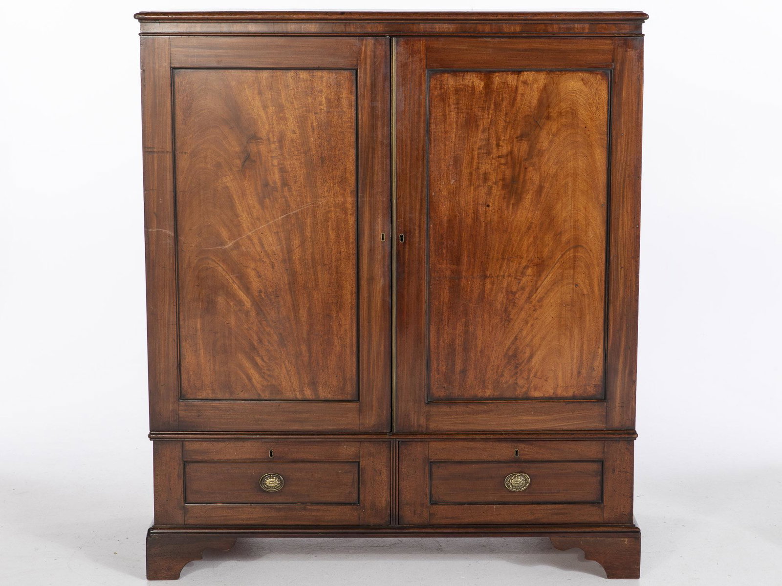 English Mahogany Linen Press: English Mahogany Linen Press, the rectangular top above paneled doors opening to sliding shelves above two drawers raised on later bracket feet. Probably the upper section to a linen press now with la