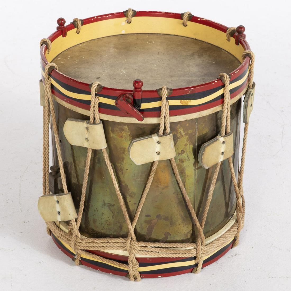 Brass Marching Band Drum: Brass Marching Band Drum, with brass and wood frame with rope stretchers and hide top, marked 'John Grey London'. MEASURMENTS: Height: 16 in. x Width: 15 in. x Depth: 15 in.